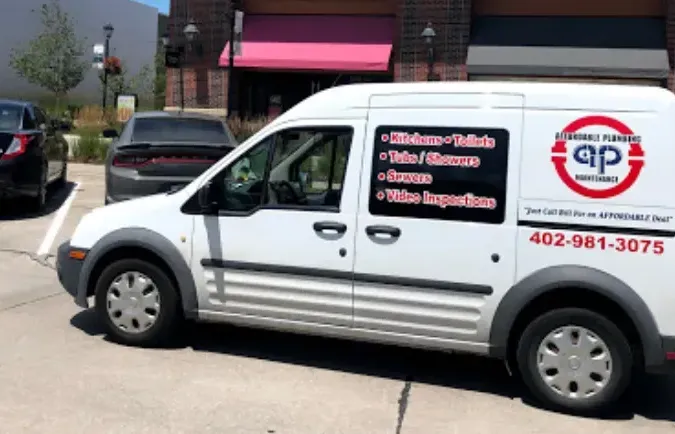A white service van with the Affordable Plumbing Maintenance logo and phone number on its side